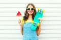 Fashion cheerful smiling woman with a slice of watermelon ice cream skateboard