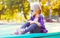 Fashion child wearing a sunglasses and checkered shirt sitting Royalty Free Stock Photo