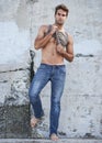 Fashion, city and portrait of man by wall in trendy, casual and stylish outfit in nature. Serious, confidence and full Royalty Free Stock Photo