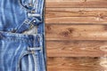 Close up of jeans pants on wooden background