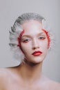 Fashion close-up portrait of a model girl in the image of a swan with a beauty amazing make-up.