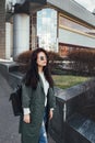 Fashion closeup portrait of nice pretty young hipster woman posing in sunglasses Outdoor .Brunette happy girl in green Royalty Free Stock Photo