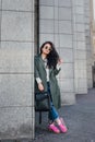 Fashion closeup portrait of nice pretty young hipster woman posing in sunglasses Outdoor .Brunette happy girl in green Royalty Free Stock Photo