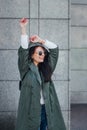 Fashion closeup portrait of nice pretty young hipster woman posing in sunglasses Outdoor .Brunette happy girl in green Royalty Free Stock Photo