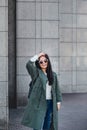 Fashion closeup portrait of nice pretty young hipster woman posing in sunglasses Outdoor .Brunette happy girl in green Royalty Free Stock Photo