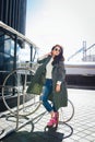 Fashion closeup portrait of nice pretty young hipster woman posing in sunglasses Outdoor .Brunette happy girl in green Royalty Free Stock Photo