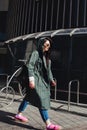 Fashion closeup portrait of nice pretty young hipster woman posing in sunglasses Outdoor .Brunette happy girl in green Royalty Free Stock Photo