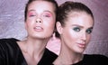 Fashion closeup portrait of two beautiful young women. Bright professional makeup