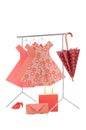 Fashion clothes: doll rack and hangers made of wire with ladies paper dresses, umbrella, purse, handbag and shoes Royalty Free Stock Photo