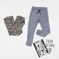 Fashion - clothes two sports pants for young; photo in neutral background