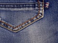 An element of jeans clothes. A seam of yellow thread. Back pocket.