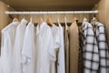 fashion clothing men shirt and female dress hanging on the wardrobe in the family dressing room at home Royalty Free Stock Photo
