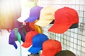 Colored baseball caps on store display