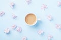 Fashion composition with morning cup of coffee and pink flowers on blue pastel background top view. Flat lay style. Royalty Free Stock Photo