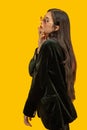 Fashion concept, Fashionable woman wear black coat and sunglasses to posing over yellow background Royalty Free Stock Photo