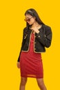 Fashion concept, Fashionable woman wear sunglasses to posing in mini red dress and black jacket Royalty Free Stock Photo