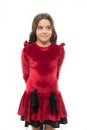 Fashion concept. Kid adorable smiling posing in red velvet dress. Kids fashion. Girl cute child wear velvet dress