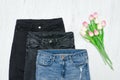 Fashion concept. Three jeans and pink tulips. Close up