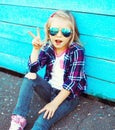 Fashion cool child wearing a sunglasses and checkered shirt s