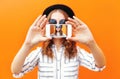 Fashion cool girl taking picture self portrait on smartphone over colorful orange Royalty Free Stock Photo