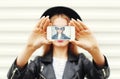 Fashion cool girl taking picture self portrait on smartphone over white Royalty Free Stock Photo