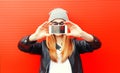 Fashion cool girl taking picture on smartphone self portrait, screen view, over red Royalty Free Stock Photo