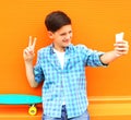 Fashion cool teenager boy is taking picture self portrait Royalty Free Stock Photo