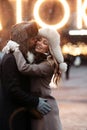 Fashion couple of lovers kissing, embracing, stand on winter street in snowy weather, Valentines Day Royalty Free Stock Photo