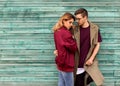 Fashion couple in their glasses with burgundy clothes posing on