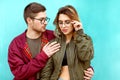 Fashion couple in their glasses with burgundy clothes posing on