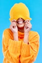 Fashion, crazy and cover with woman and beanie in studio for hiding, winter and goofy. Playful, happiness and smile with