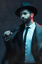 Fashion, criminal and man with bat for violence for vintage, retro and Victorian gangster on dark background. Crime