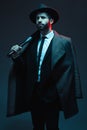 Fashion, criminal and man in studio with bat for vintage, retro and Victorian gangster on dark background. Crime