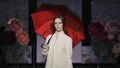 Catwalk charming woman open umbrella defile model show closeup evening vogue 4K. Royalty Free Stock Photo