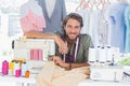 Fashion designer leaning on sewing machine Royalty Free Stock Photo