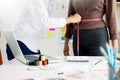 Fashion designer measuring on body part of women for a tailor ma Royalty Free Stock Photo