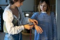 Fashion designer woman takes measurements with measuring tape of client before tailoring clothes Royalty Free Stock Photo