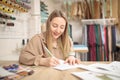 Fashion designer at work. Confident young fashion designer drawing sketch Royalty Free Stock Photo