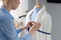 Fashion designer working with blue tailor dummy in her workshop Royalty Free Stock Photo