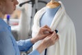 Fashion designer working with blue tailor dummy in her workshop Royalty Free Stock Photo