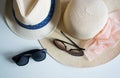 Fashion details. Women`s and men`s hat and sunglasses on pink background...