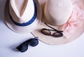 Fashion details. Women`s and men`s hat and sunglasses on pink background.