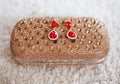 Fashion earrings style red jewels with diamonds on golden purse Royalty Free Stock Photo