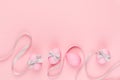 Fashion easter background - pink eggs with grey ribbon quaint stripes as border on pastel pink color.