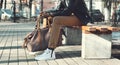 Fashion elegant african man with bag sits on the bench