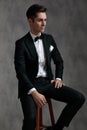 Fashion elegant groom wearing tuxedo and looking to side Royalty Free Stock Photo