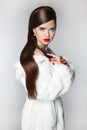 Fashion elegant woman in fur coat, Brunette with red lips, hairs Royalty Free Stock Photo