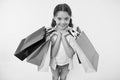 Fashion expert. Child cute shopping expert helps carry packages during shopping. Little shop expert. Girl shopaholic