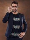 Fashion, eyewear and portrait of male person, studio and clothing isolated on background. Confident, pose and glasses Royalty Free Stock Photo