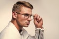 Fashion eyewear you want to wear. Serious man fix glasses isolated on white. Trendy eyeglasses. Vision correction